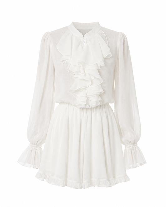 A white long-sleeve blouse with a high ruffled collar, bow at the neckline, gathered sleeves with ruffled cuffs, and a flared skirt, shown on a plain white background.